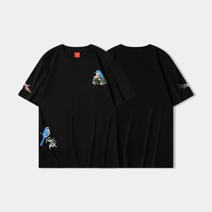 Black short-sleeve T-shirt with colorful embroidered bluebirds and floral designs on front and sleeves