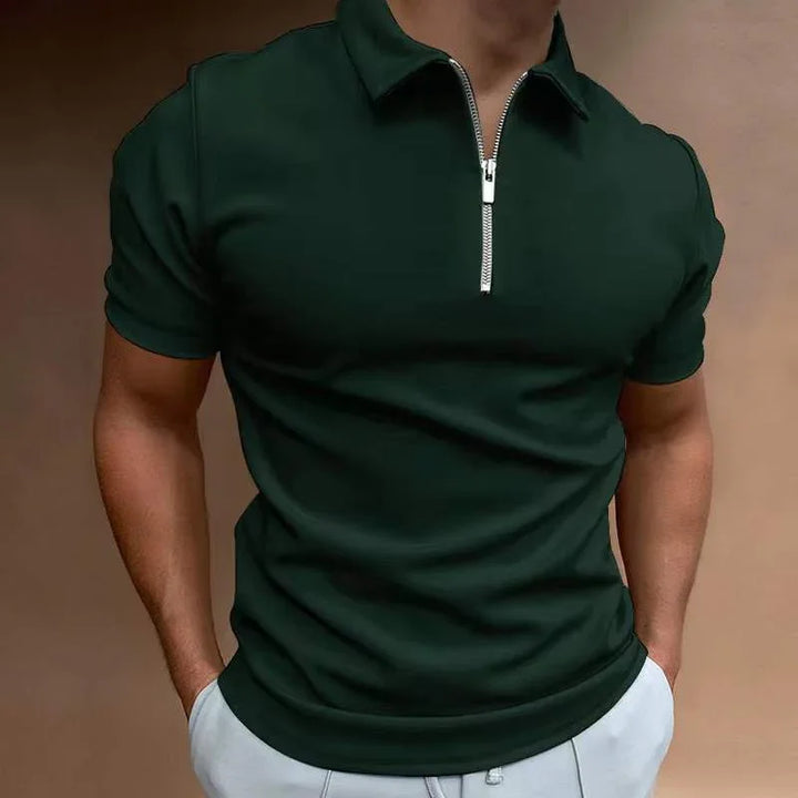 man wearing black short sleeve polo shirt with silver zipper and white pants