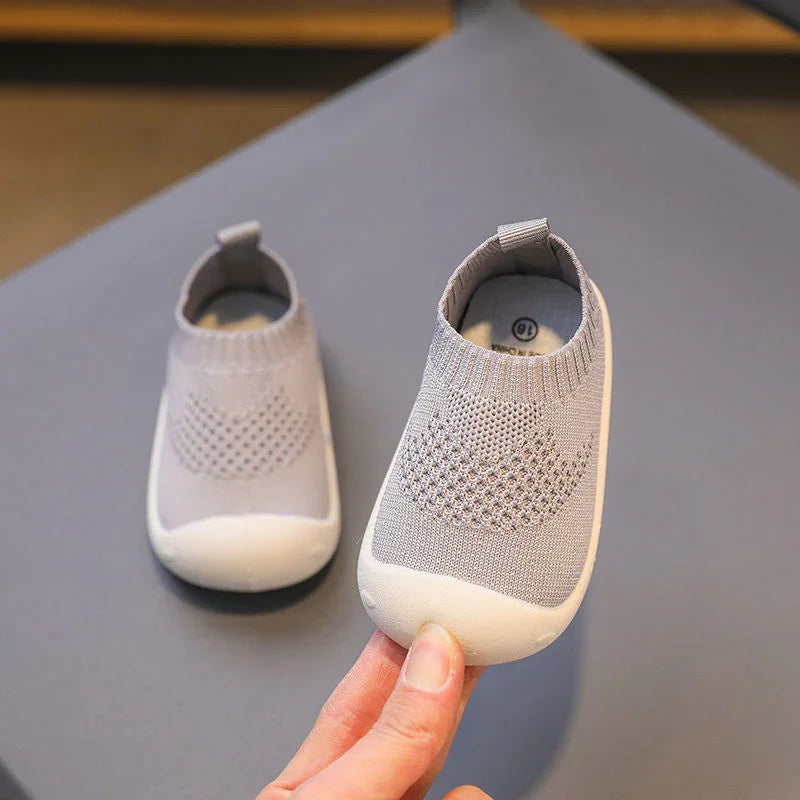 Light grey baby soft sole shoes with knitted heart design and white rubber toe cap