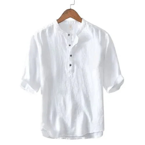 White casual long-sleeve linen shirt with buttoned collar on wooden hanger