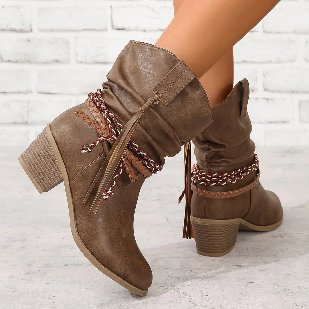 Brown mid-calf slouch boots with stacked heels and braided decorative straps