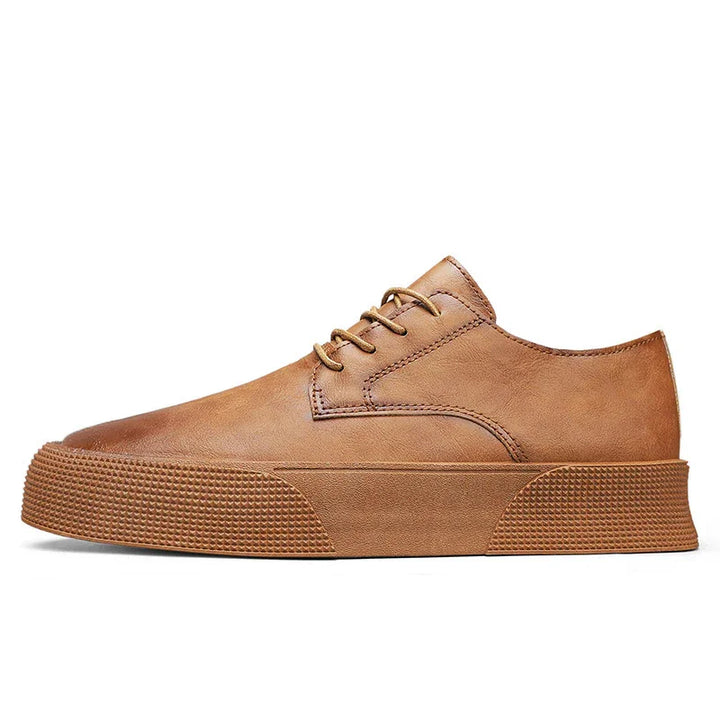 Side view of a brown leather casual lace-up sneaker with textured rubber sole on white background