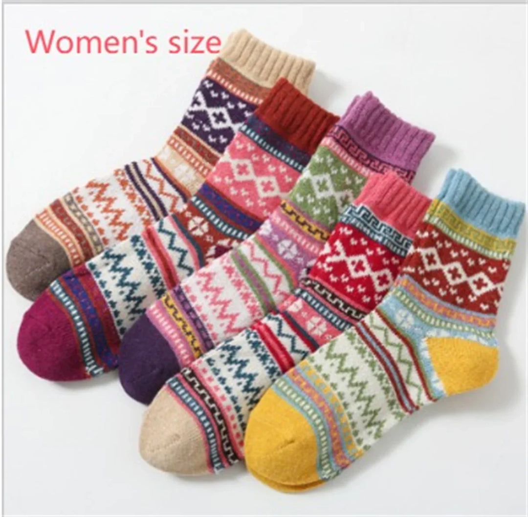 Set of colorful women's wool socks with Nordic and geometric patterns on white background
