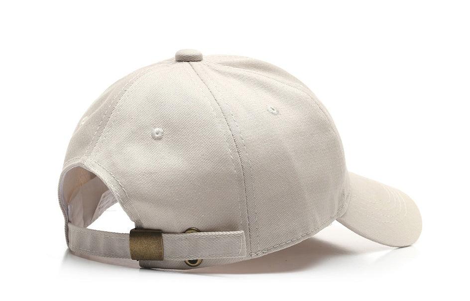 Beige adjustable baseball cap with metal buckle on white background
