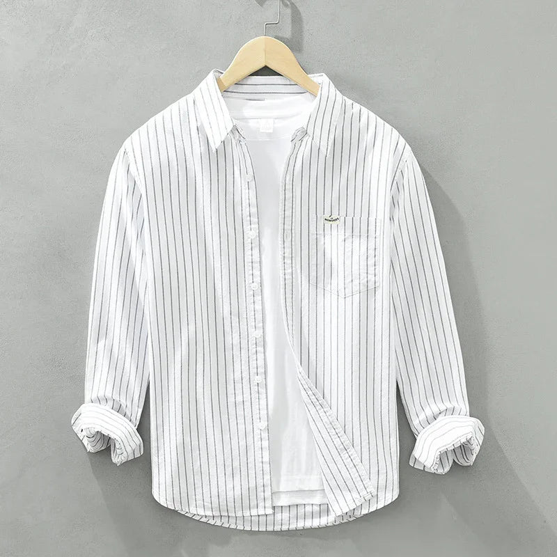White vertical striped button-up shirt with chest pocket, displayed on wooden hanger