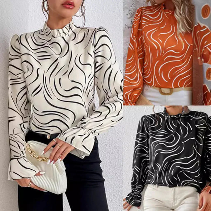 Women wearing stylish long-sleeve swirl print blouses in white, orange, and black colors, paired with pants