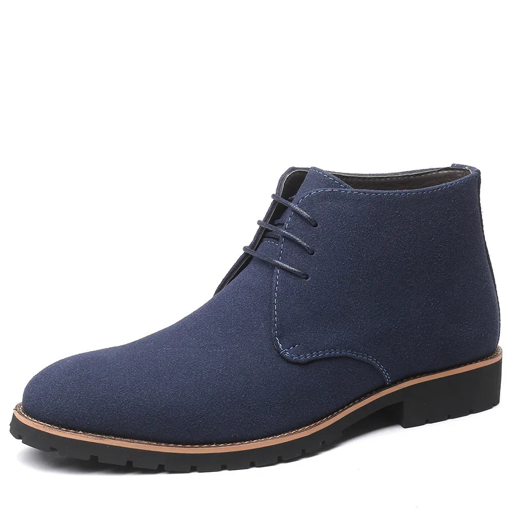 Navy blue suede men's desert boots with black rubber soles and brown trim