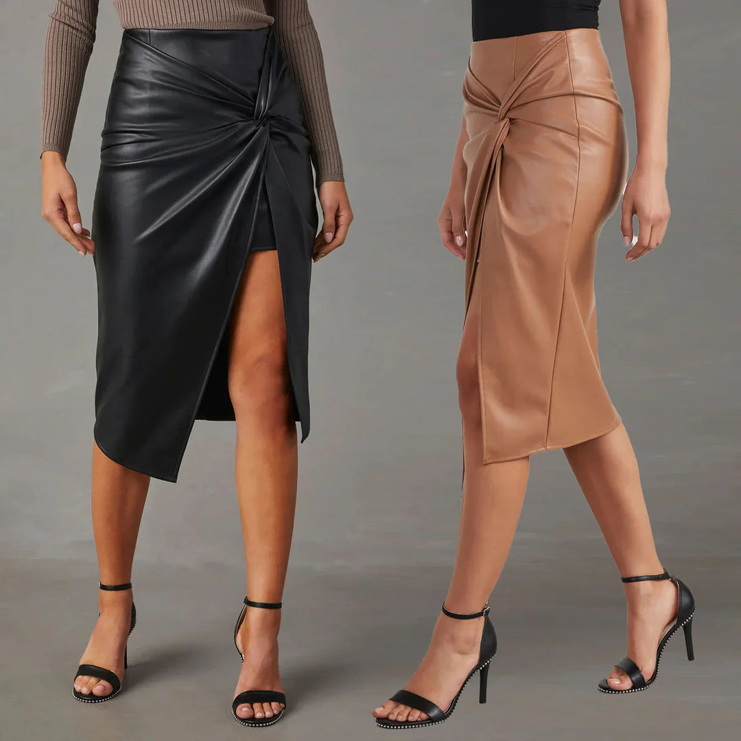 Two women wearing asymmetrical faux leather midi skirts in black and tan with front slit and twist detail