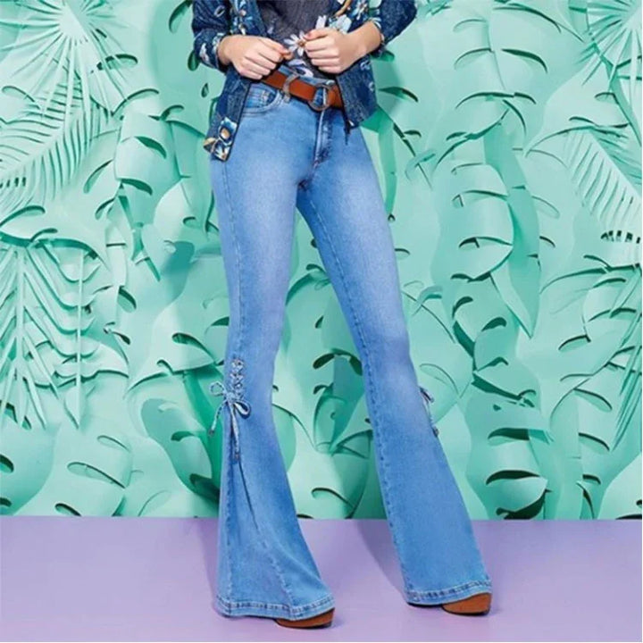 Women wearing blue high-waisted flared jeans with lace-up detail on sides and brown belt