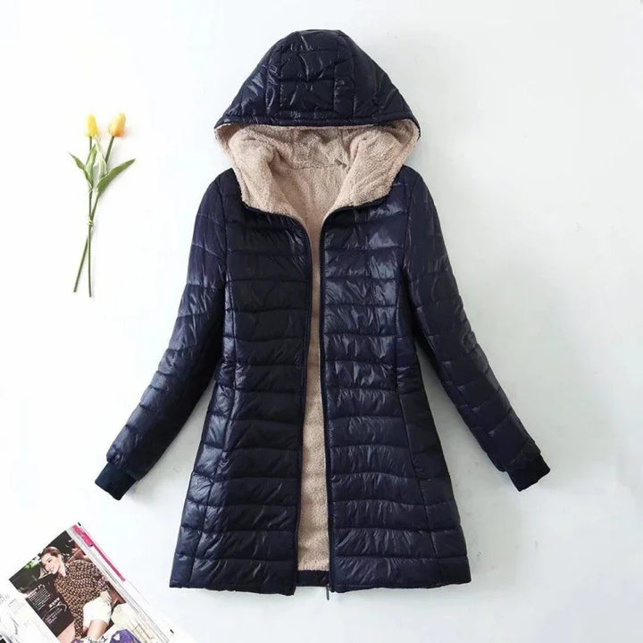 Navy blue quilted hooded winter coat with beige fleece lining, long sleeves, and zipper front