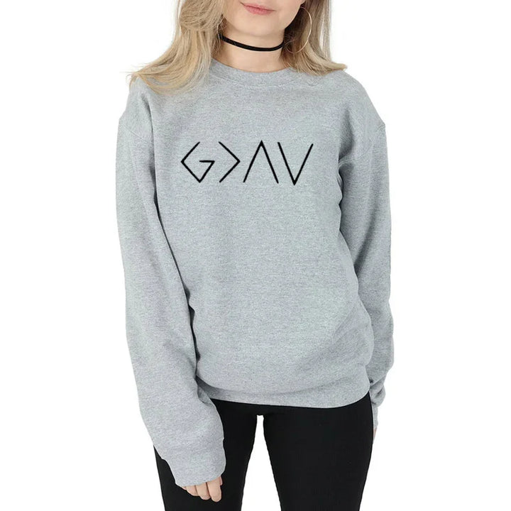Woman wearing a light gray sweatshirt with black geometric text design and black pants