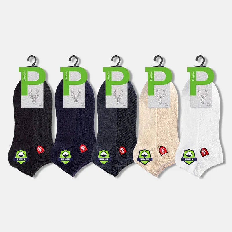 Five pairs of ankle socks in black, navy, gray, beige, and white with green tags and leaf logos