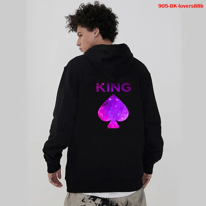 Young man in black hoodie with purple galaxy 'KING' and spade graphic on back