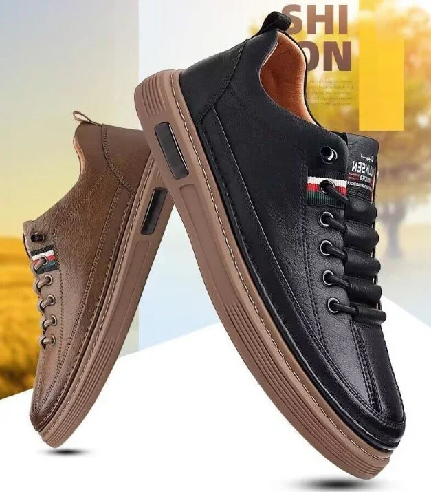 Pair of stylish casual men's sneakers in black and brown leather with brown rubber soles and lace-up design