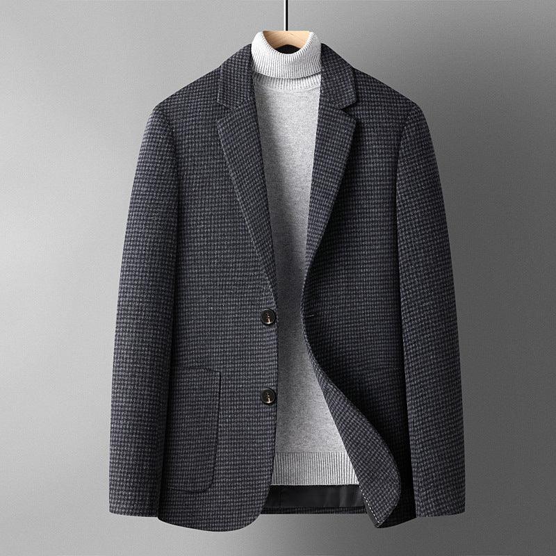 Men's dark houndstooth blazer layered over light gray turtleneck sweater on hanger