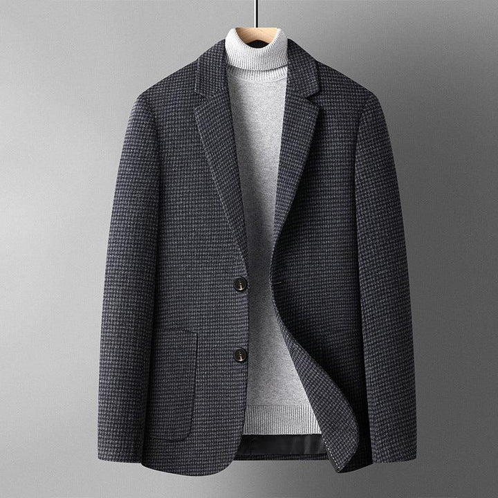 Men's dark houndstooth blazer layered over light gray turtleneck sweater on hanger