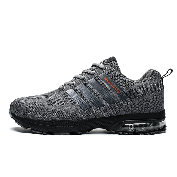 Gray knit running shoe with black sole, transparent air cushion, and orange "keep running" text