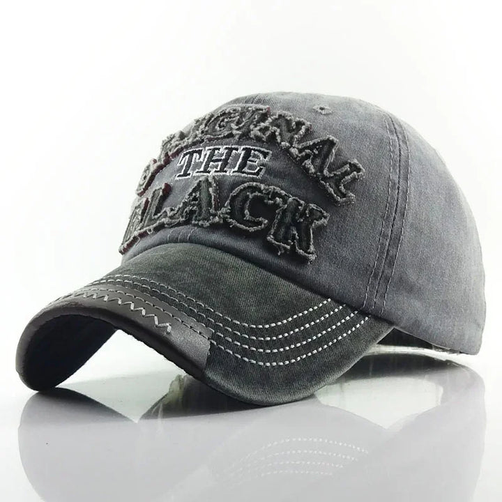Gray distressed baseball cap with white stitched text 'ORIGINAL THE BLACK' on front panel