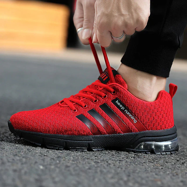Red breathable running shoe with black sole and stripe details, labeled 'keep running'