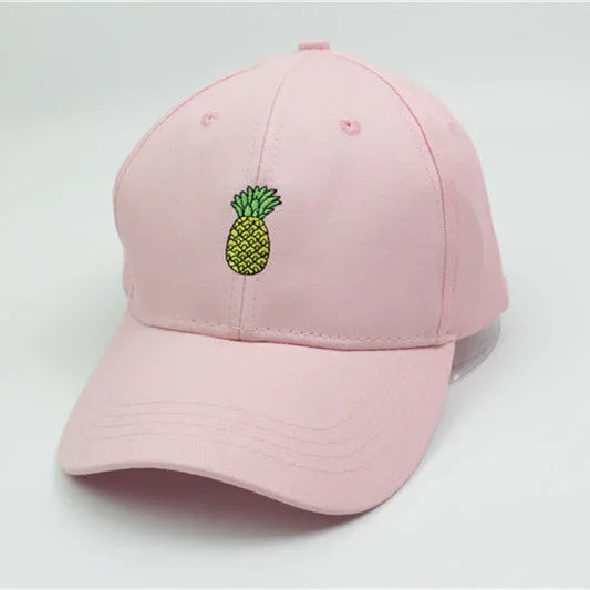 Light pink baseball cap with small embroidered green and yellow pineapple on front