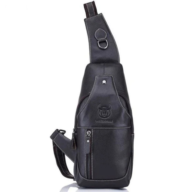 Black leather sling backpack with front zipper pocket and embossed bull logo against white background