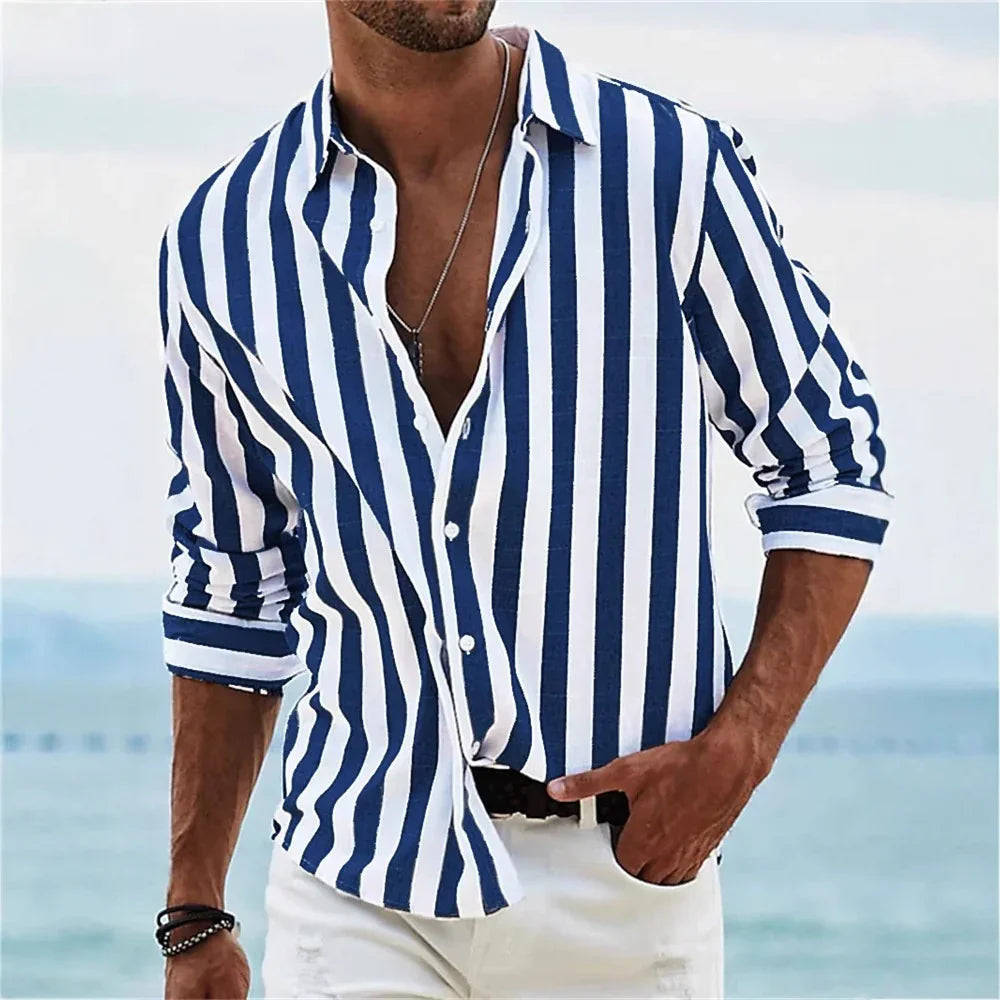 Man wearing blue and white vertical striped casual shirt with rolled sleeves by the beach