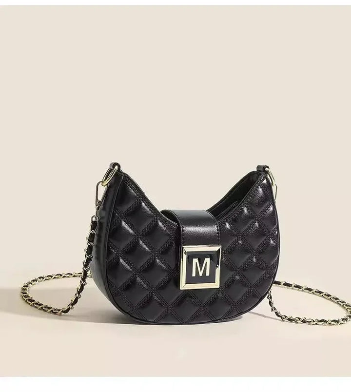 Black quilted leather crossbody bag with gold chain strap and M logo buckle