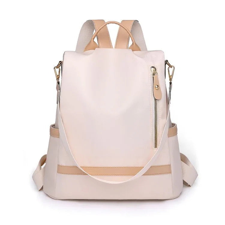 Stylish beige and tan leather backpack with front zipper pocket and adjustable straps