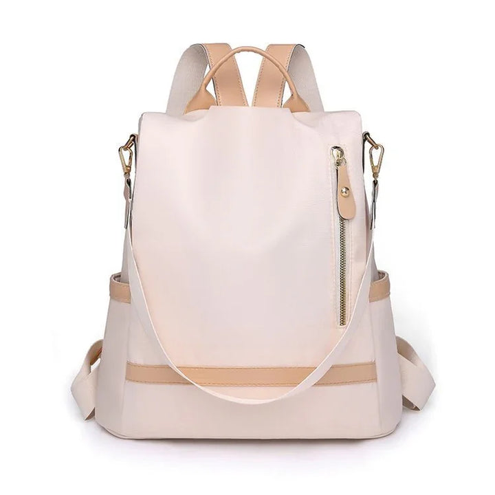 Stylish beige and tan leather backpack with front zipper pocket and adjustable straps