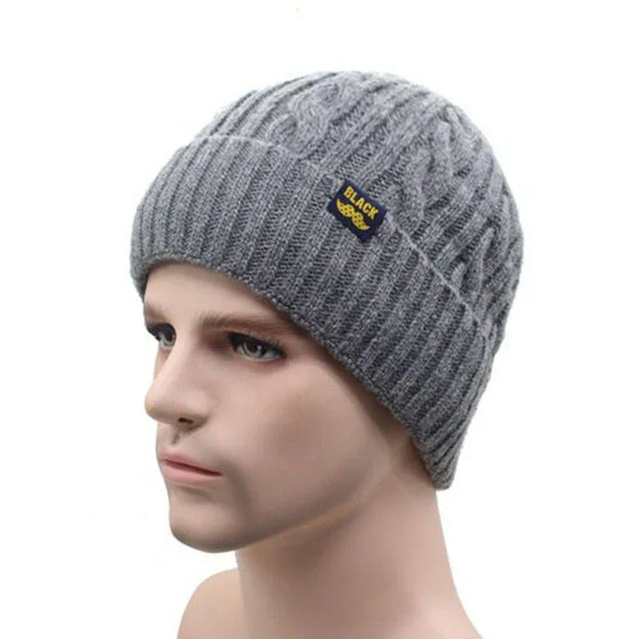 Gray knitted beanie hat with cable pattern and BLACK label on male mannequin head