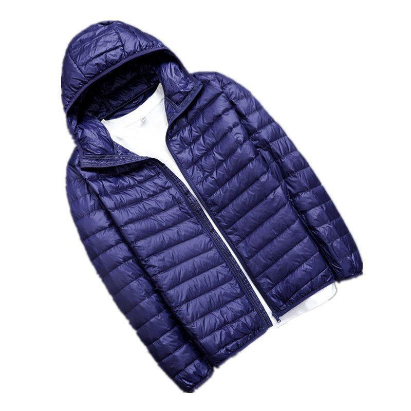 Navy blue lightweight puffer jacket with hood, unzipped over white shirt on white background