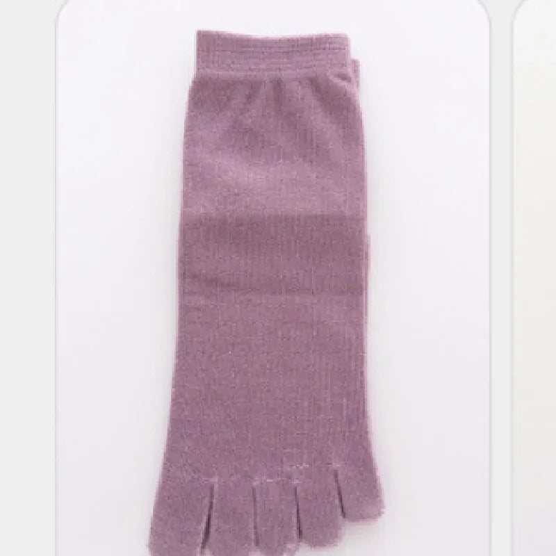Folded lavender-colored five-toe socks with ribbed cuff on white background
