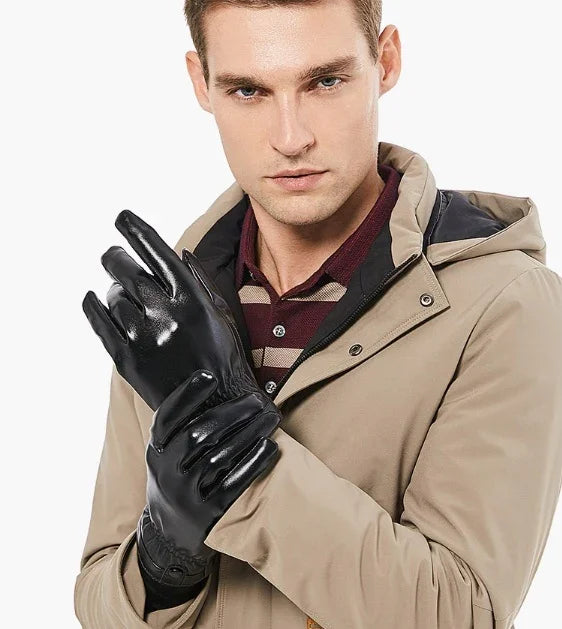 Man wearing black leather gloves and beige jacket over maroon striped shirt on white background