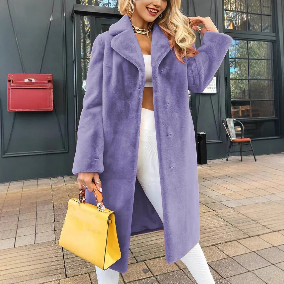 Woman wearing a long lavender faux fur coat with white outfit and holding yellow handbag outdoors