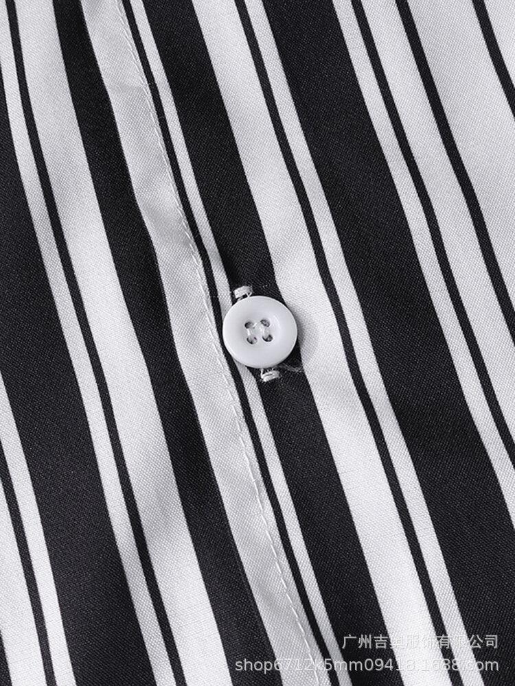 Close-up of black and white striped fabric with a white button and detailed stitching