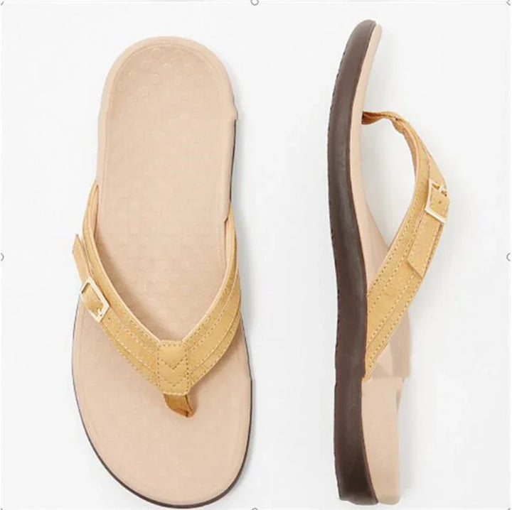 Beige cushioned flip-flops with adjustable straps and dark brown soles on white background
