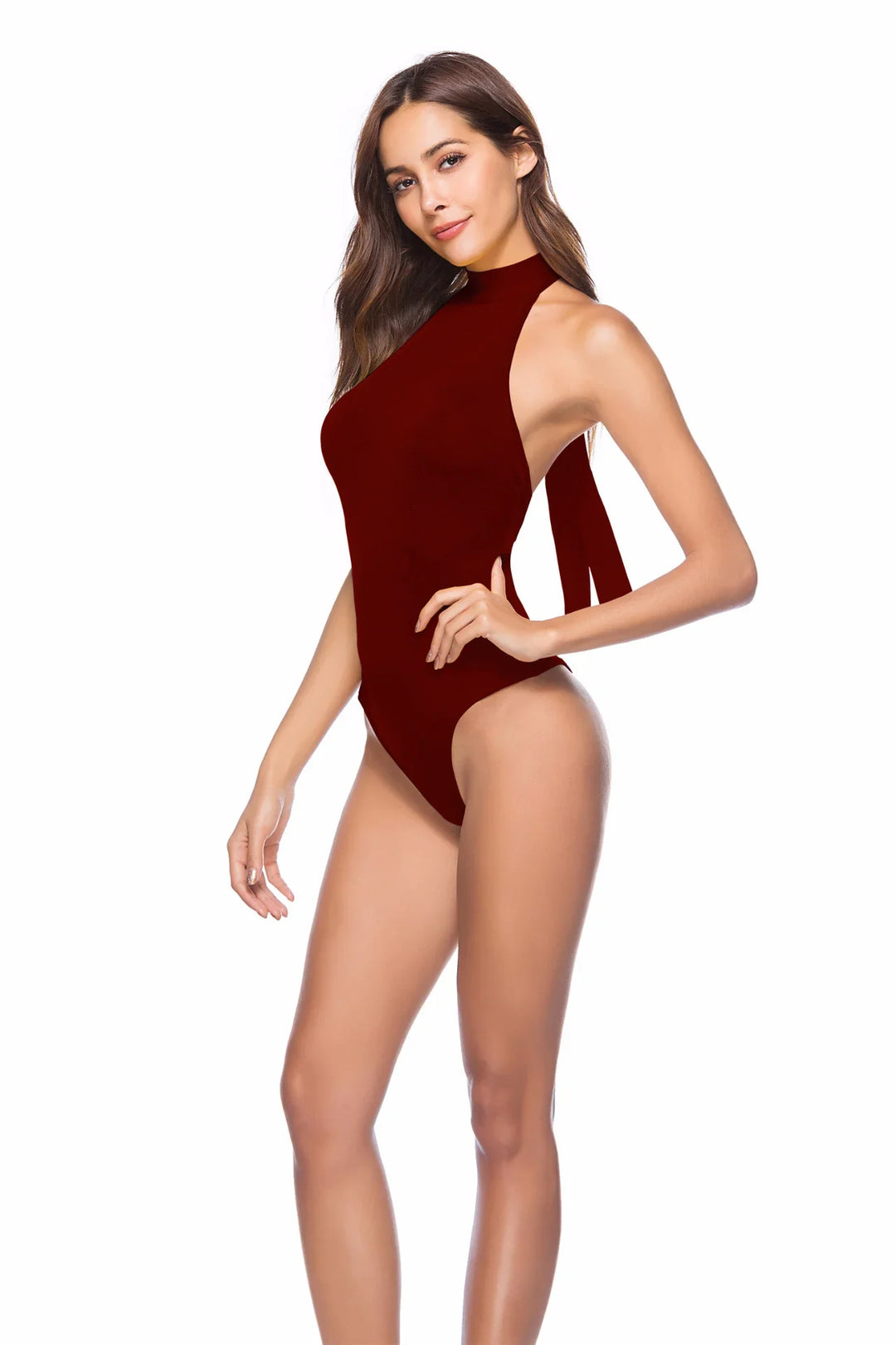 woman wearing dark red high neck backless swimsuit posing against white background