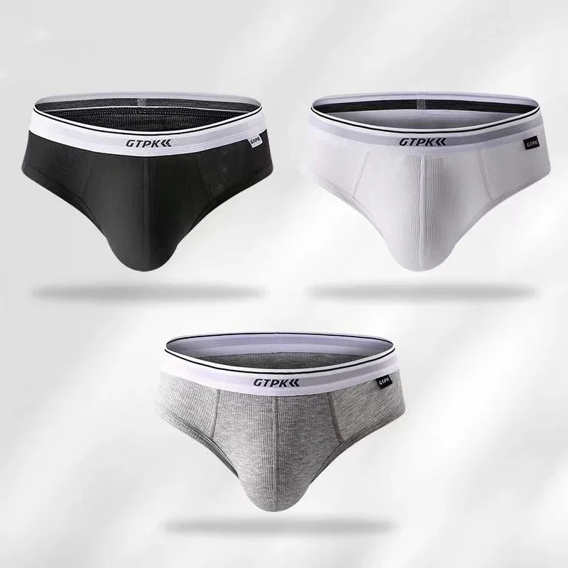 Set of three men's GTPK briefs in black, white, and gray with white waistbands on white background