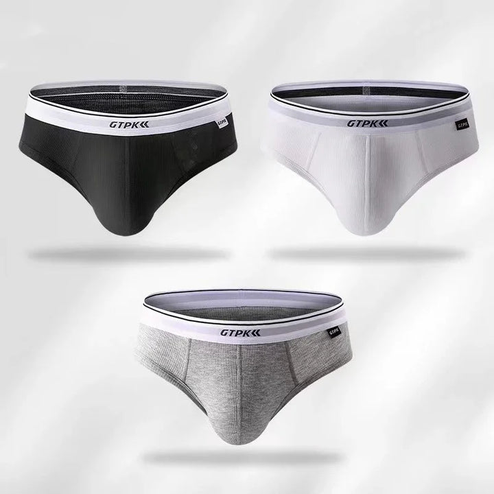 Set of three men's GTPK briefs in black, white, and gray with white waistbands on white background