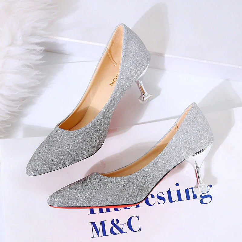 silver glitter high heel shoes with shiny metallic heels on white surface with text