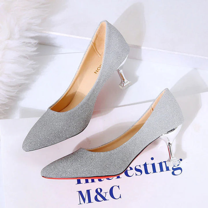 silver glitter high heel shoes with shiny metallic heels on white surface with text