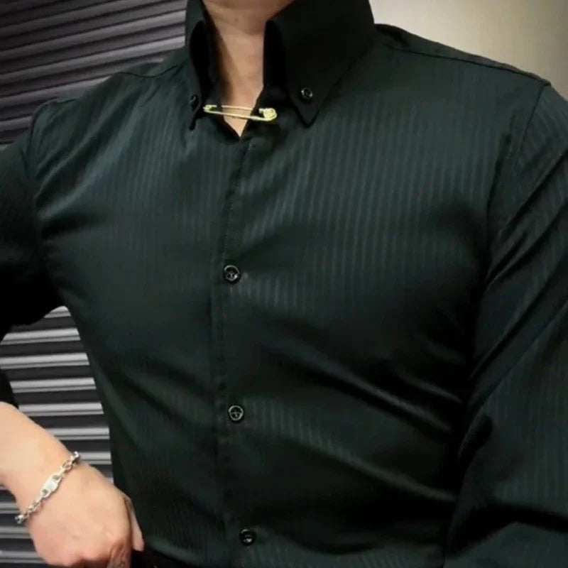 Close-up of a man wearing a fitted black striped dress shirt with gold safety pin collar accessory