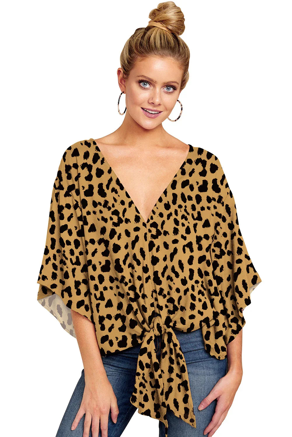Woman wearing leopard print V-neck blouse with tie front and hoop earrings