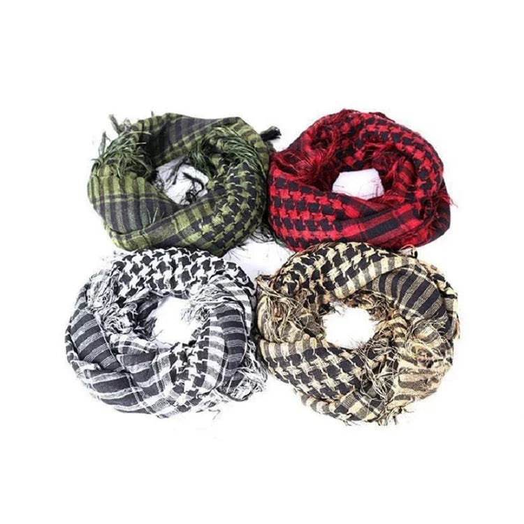 Four folded patterned scarves in green, red, black and white, beige and black on white background