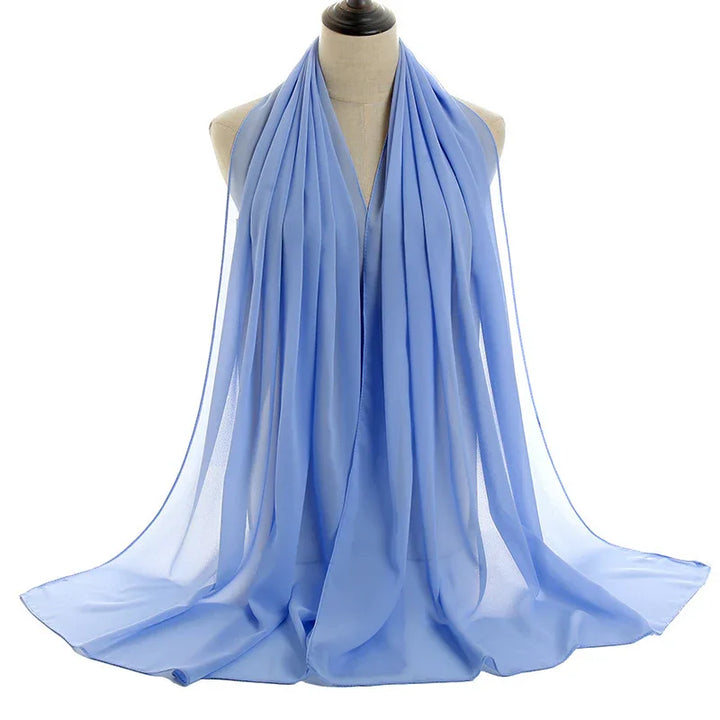 Light blue chiffon scarf draped elegantly on beige mannequin against white background
