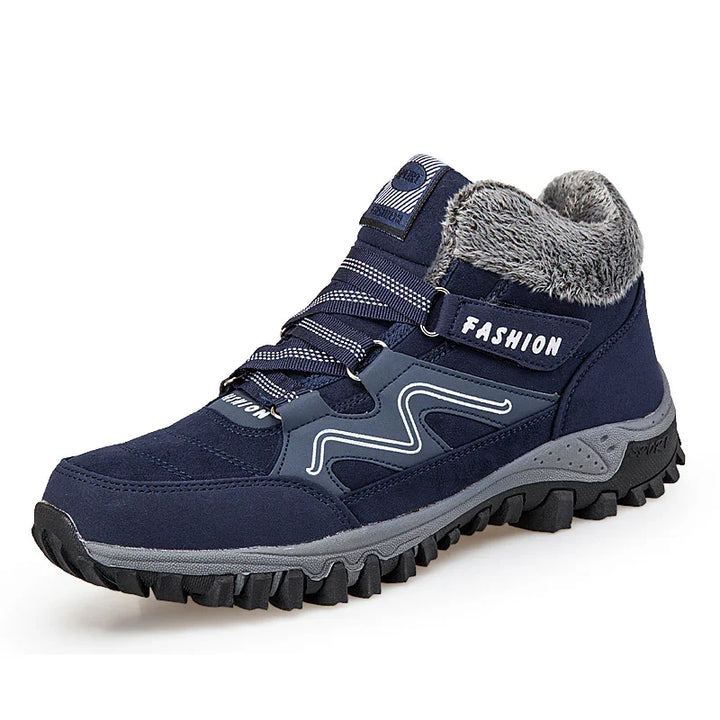Navy blue winter hiking boot with gray fur lining, rugged black sole, and 'FASHION' strap detail