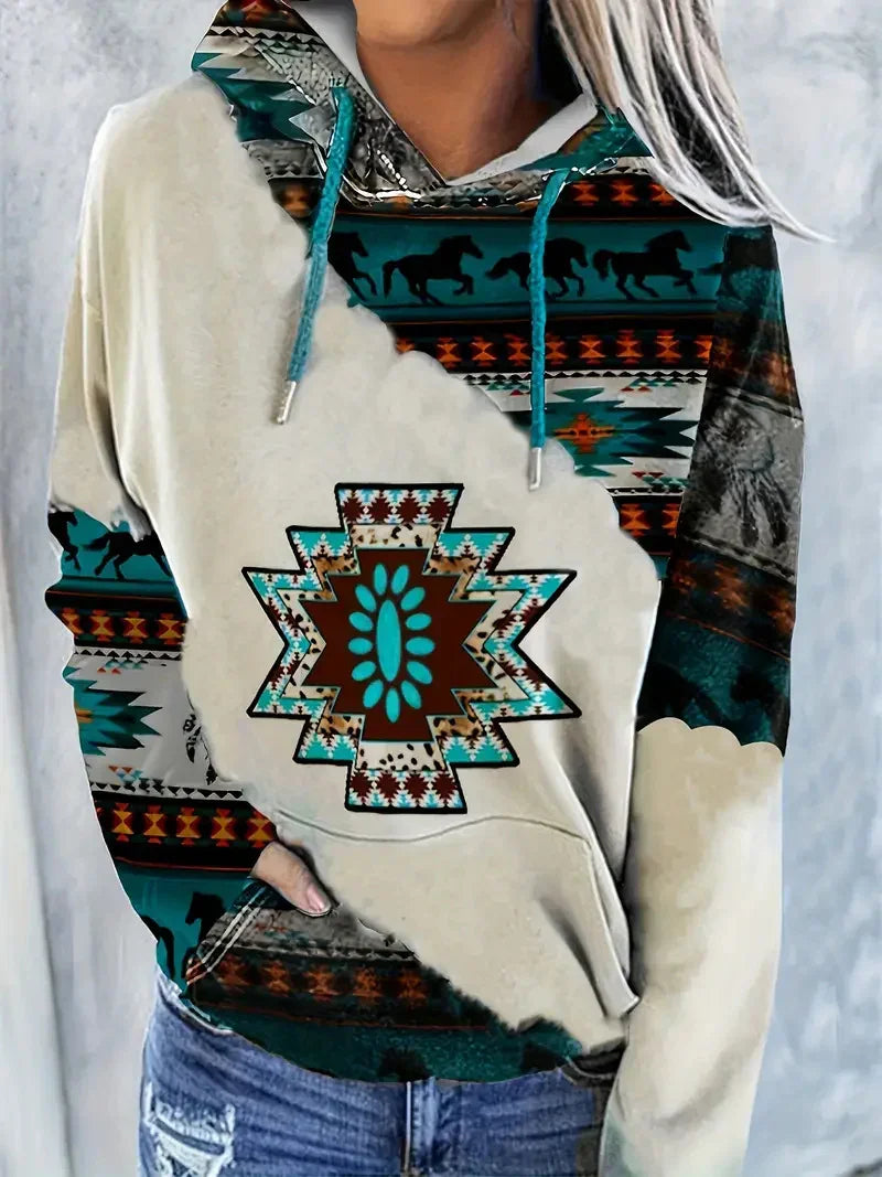 Woman wearing boho style hoodie with turquoise and brown Southwestern geometric and horse patterns