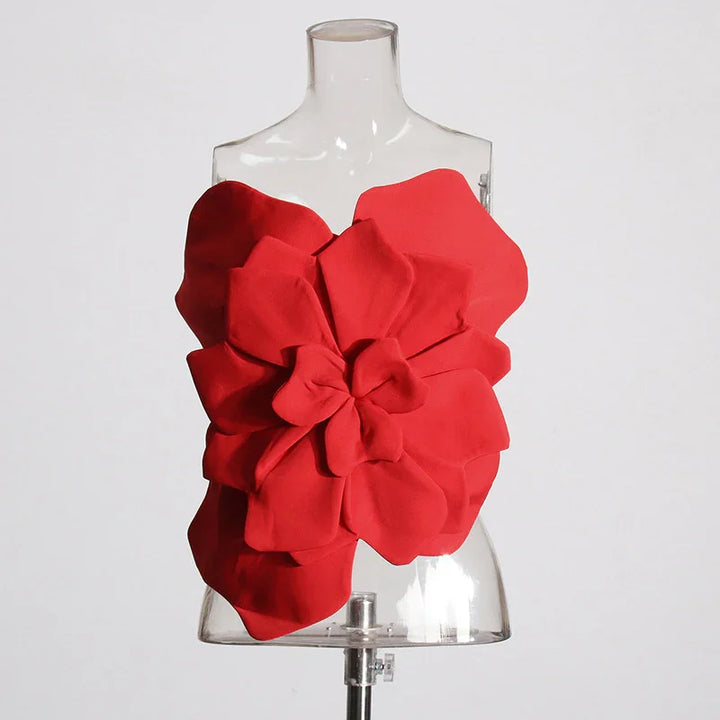 Red sculptural floral strapless top displayed on clear mannequin against white background