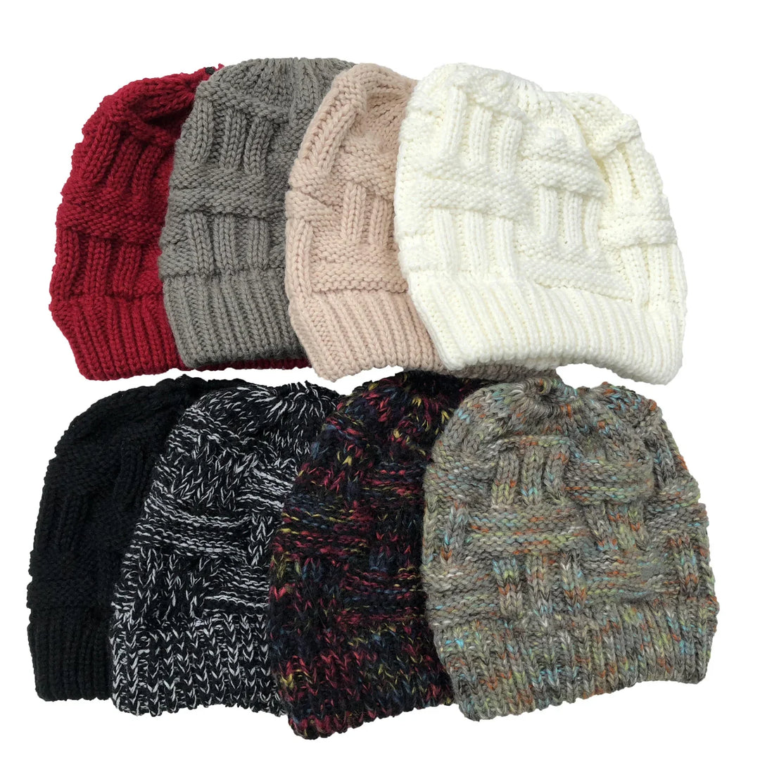 Collection of eight knitted winter beanies in various solid and multicolor patterns arranged on white background