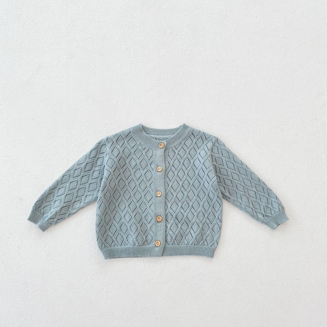 Light blue knitted baby cardigan with diamond pattern and wooden buttons on white background